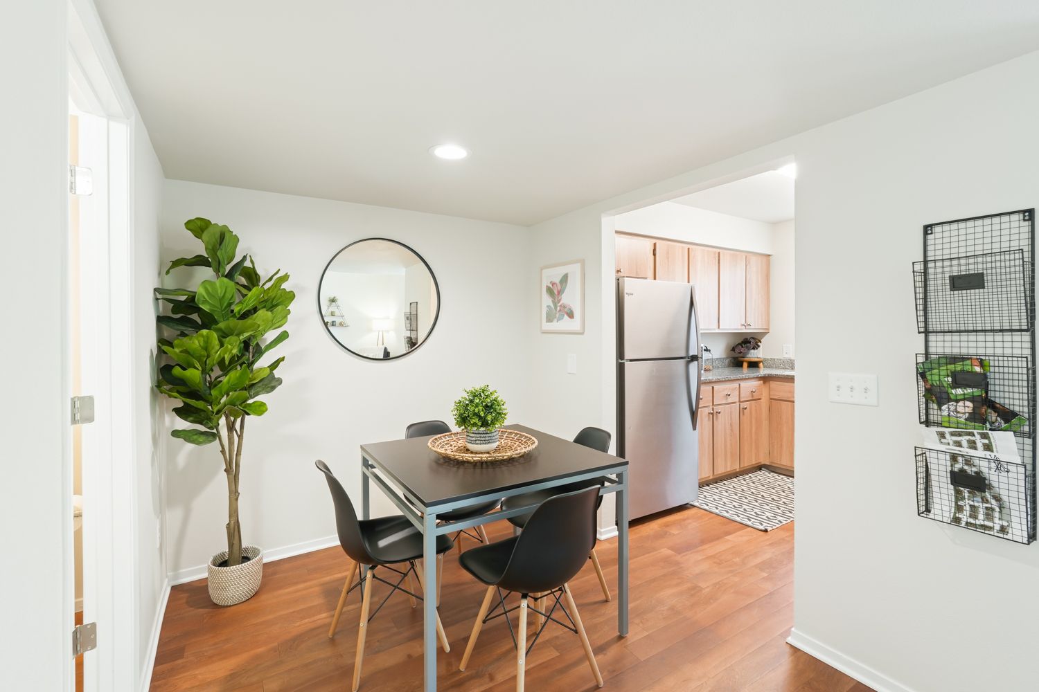 dining room with wood-style flooring and a square wooden table for four